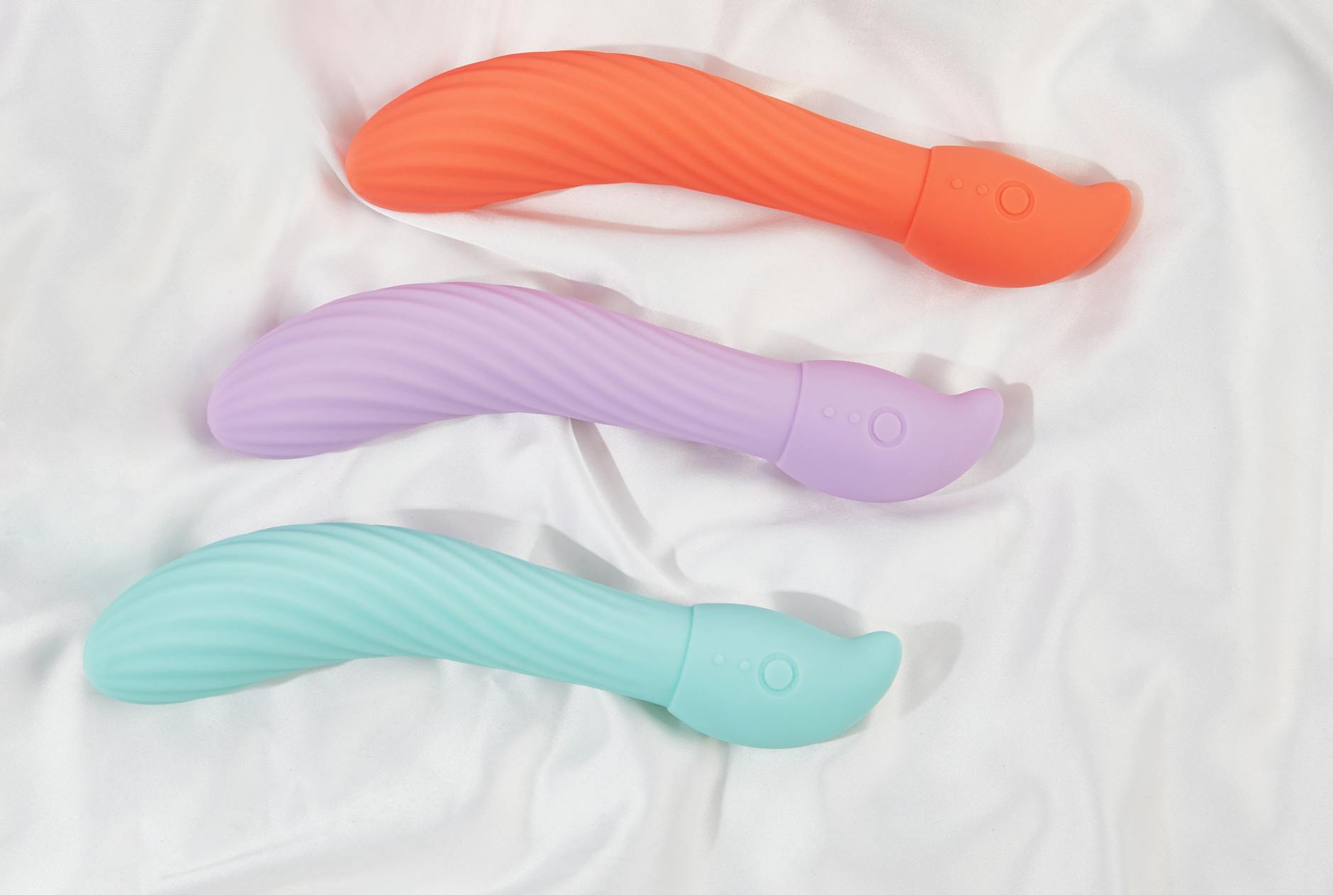A blue silicone sex toy held in hand against a solid purple background, promoting self-love and sexuality.