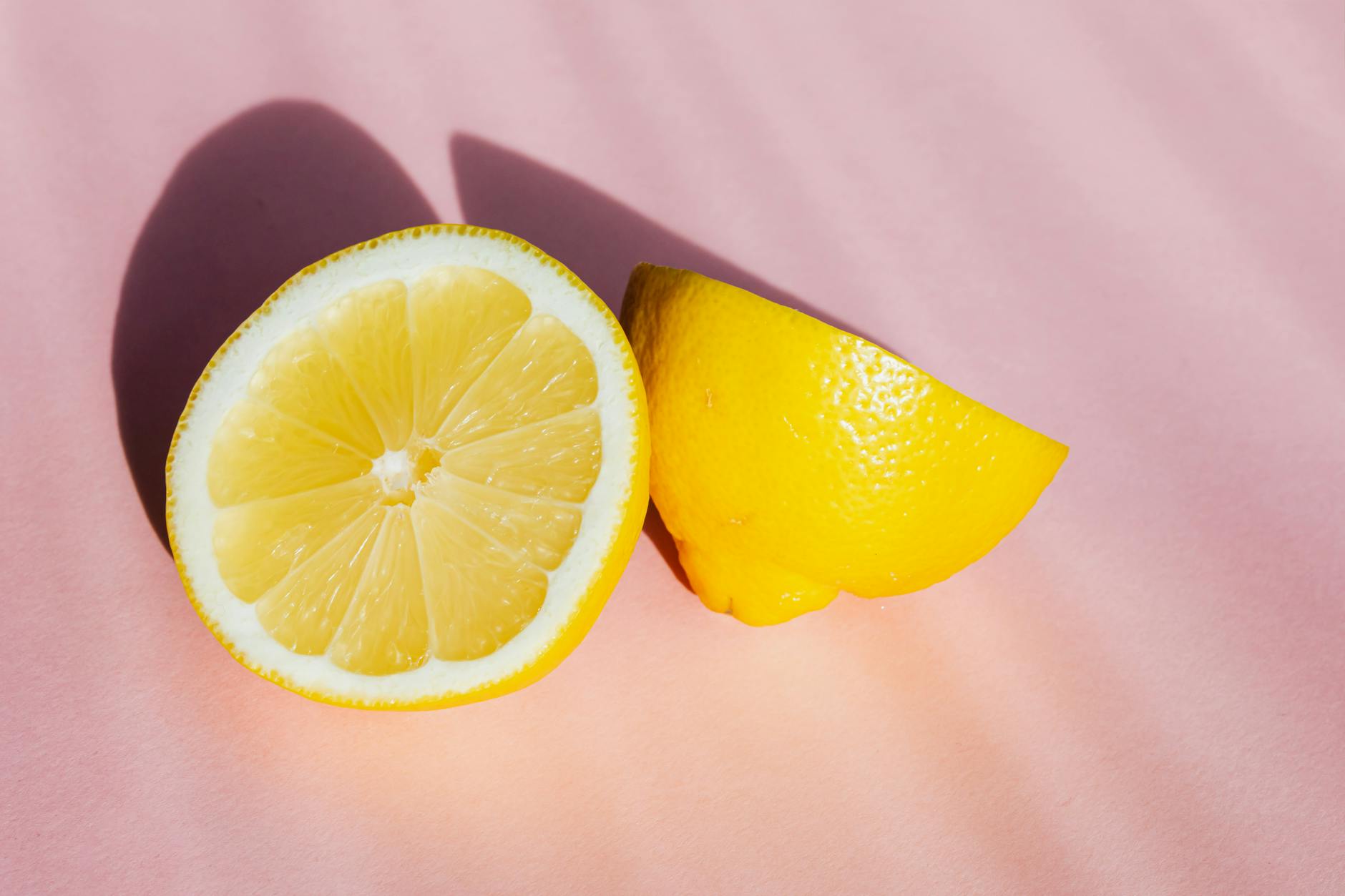 Yellow silicone vibrator surrounded by fresh bananas on bright yellow background