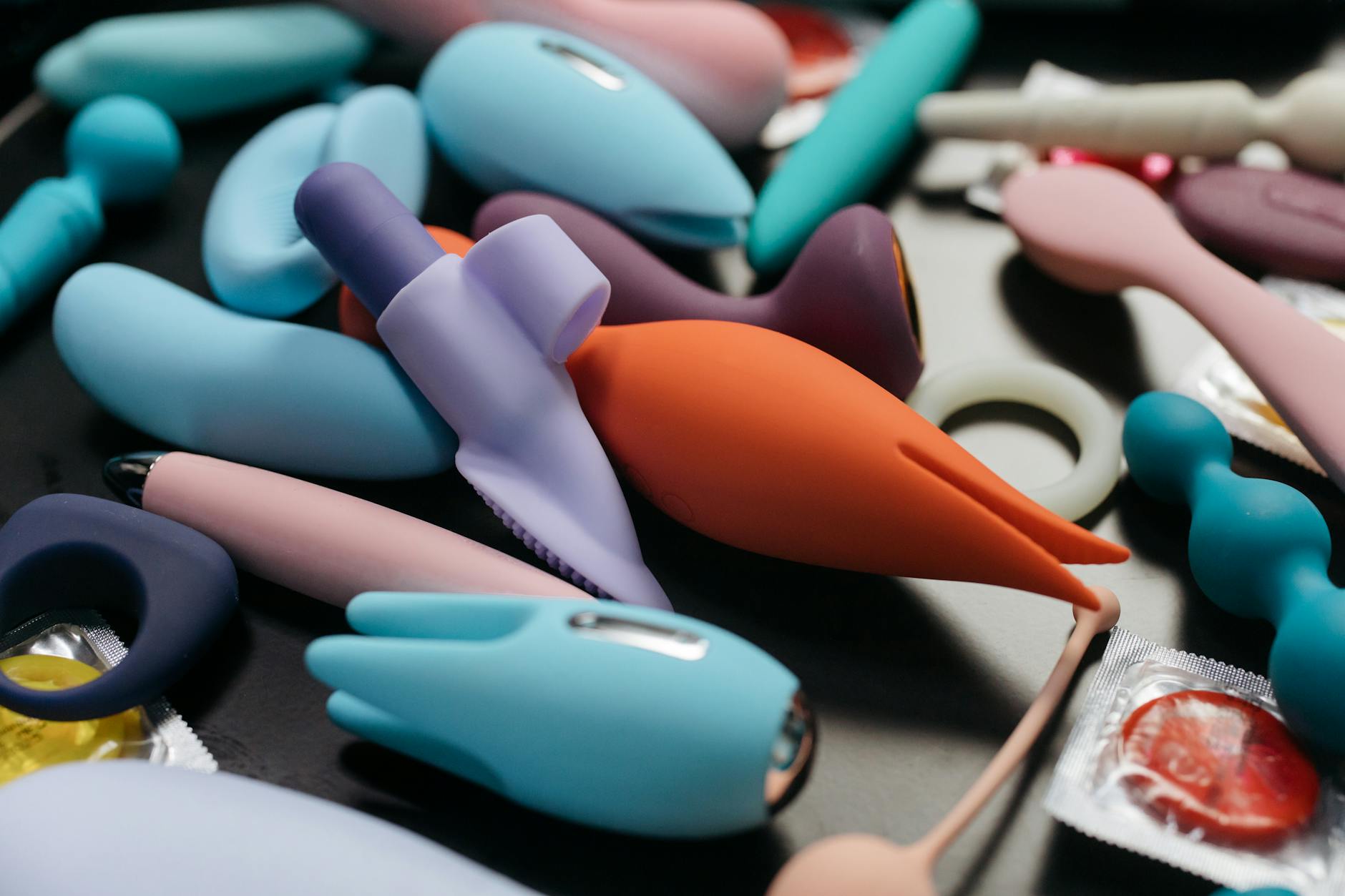 An array of vibrant adult toys including lemon vibrators and other designs in a close-up view.