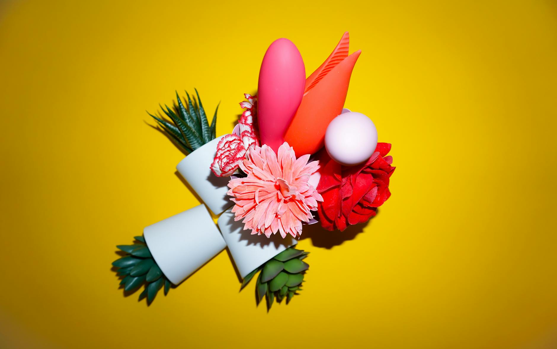 Woman holding colorful vibrators demonstrating personal wellness options during different cycle phases.